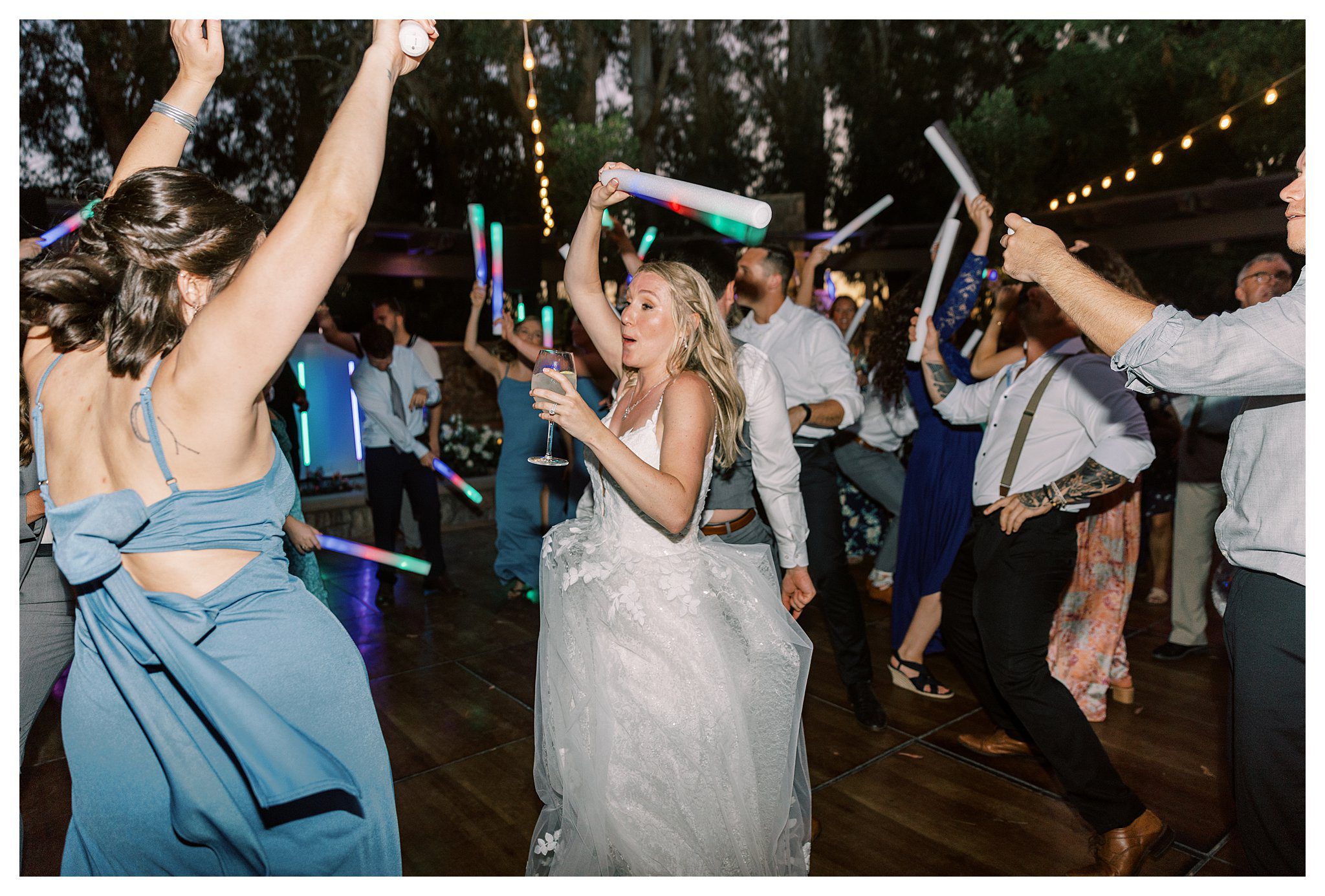 The bride and her friends dancing with glow sticks during the reception at Walnut Grove.