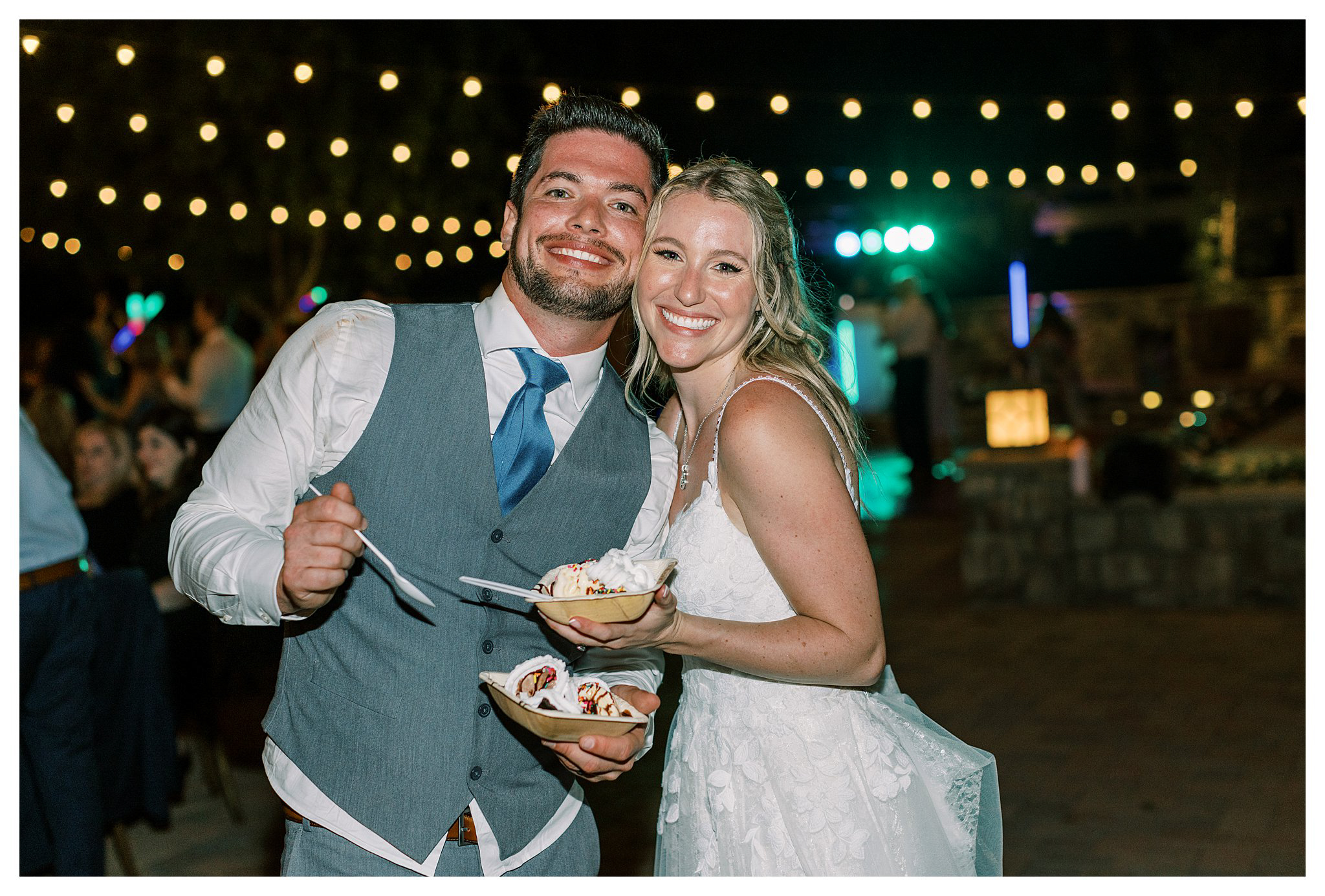 The newlyweds enjoying ice cream and a sundae bar at Walnut Grove wedding.  