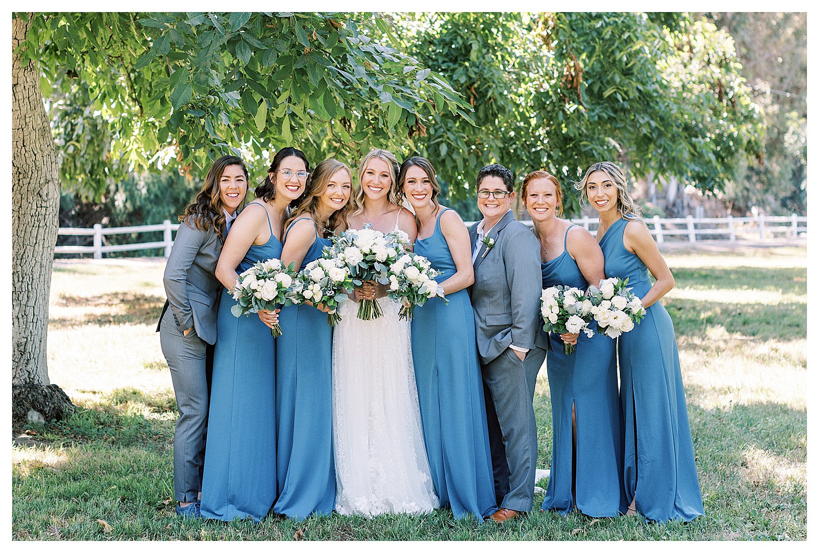 Bride and her bridesmaids smiling at Walnut Grove, in Moorpark, Ca.