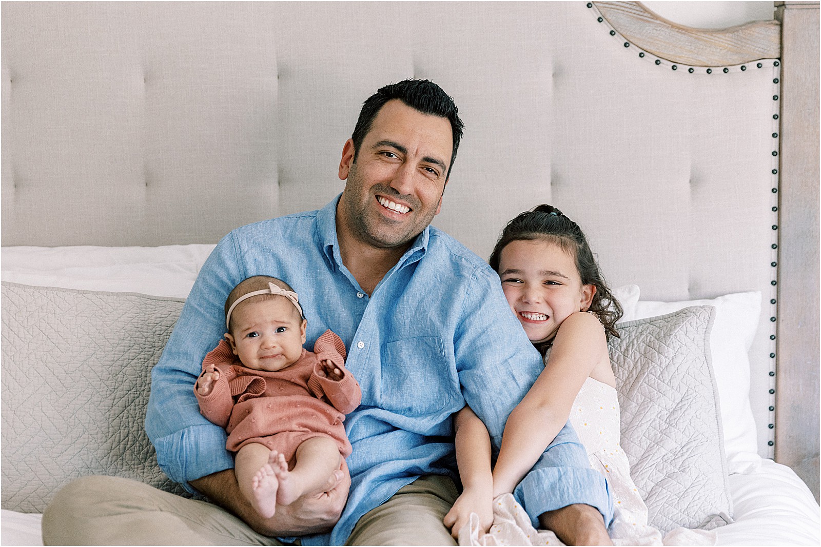 Dad snuggling with his girls during a family session in Thousand Oaks.
