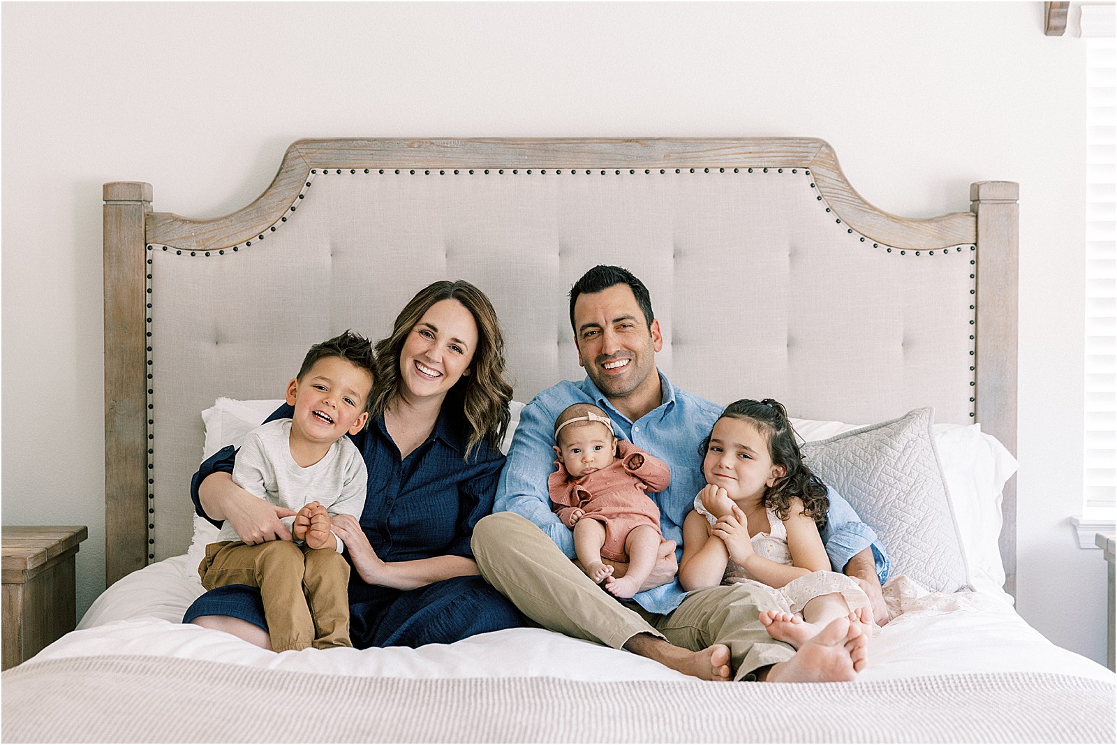 Parents and three children snuggled together during Thousand Oaks in-home session