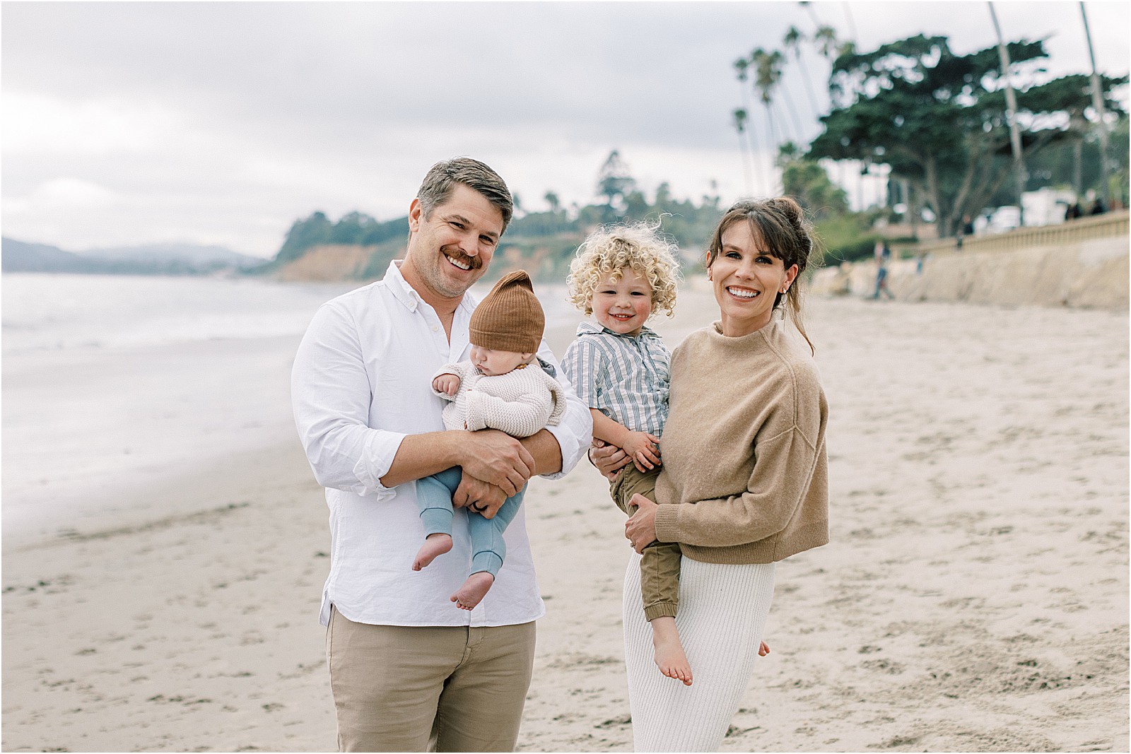 Overcast family beach session with soft, natural light and muted ocean tones