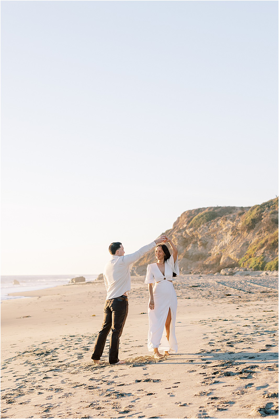 Romantic moment as couple dances during their Malibu engagement session.