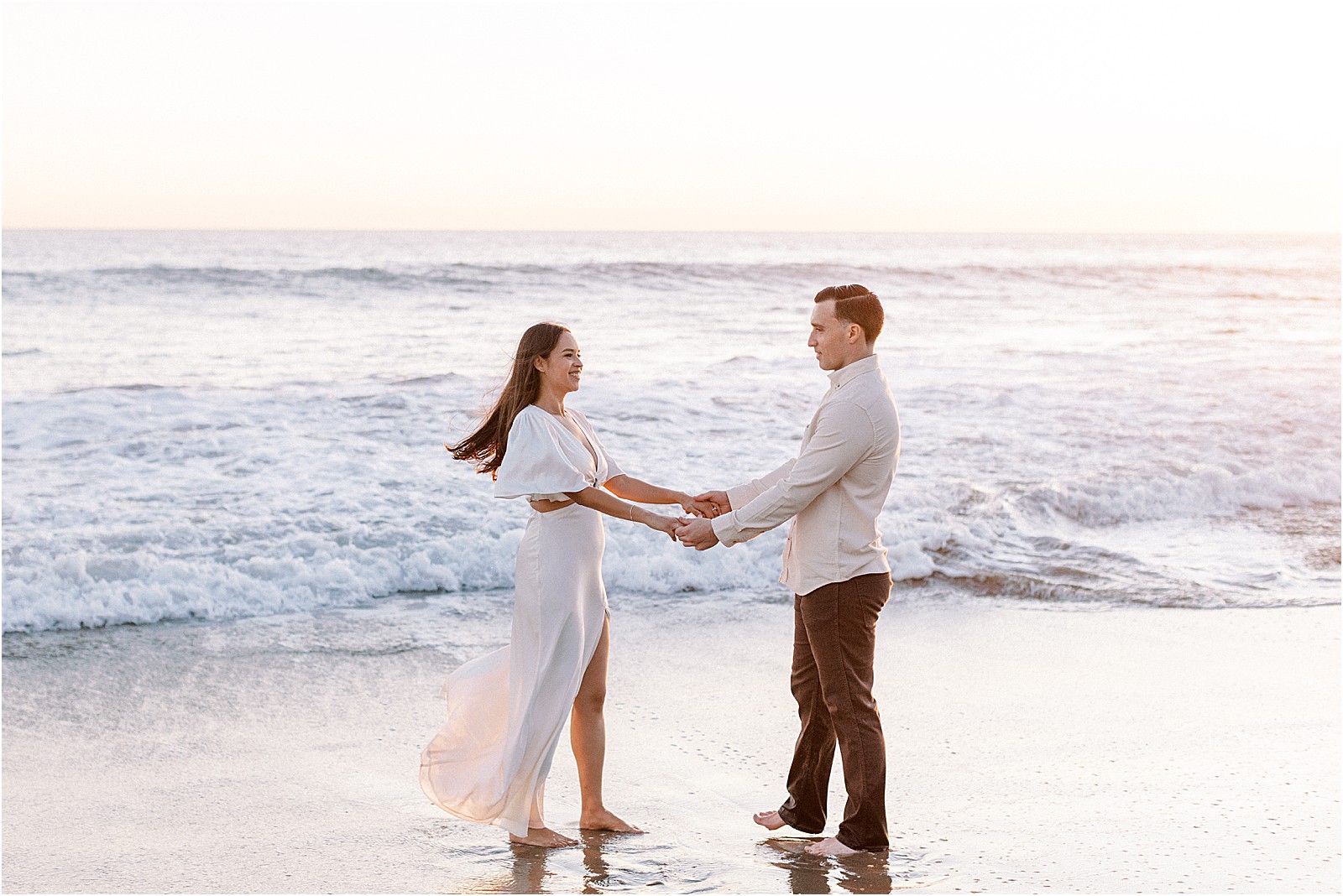 Playful, romantic moment with couple on the beach in Malibu.
