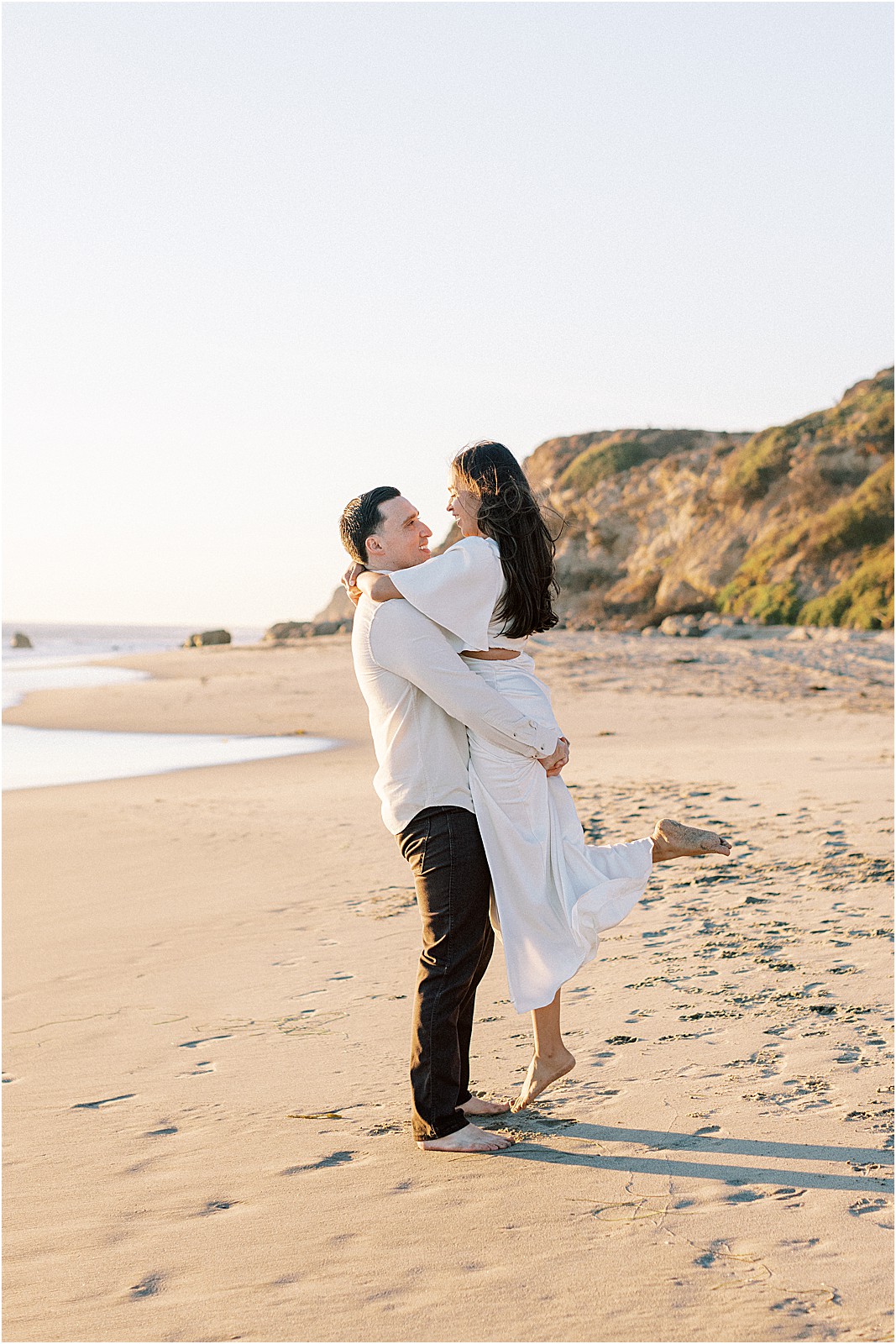 Romantic moment during couples Malibu engagement session.