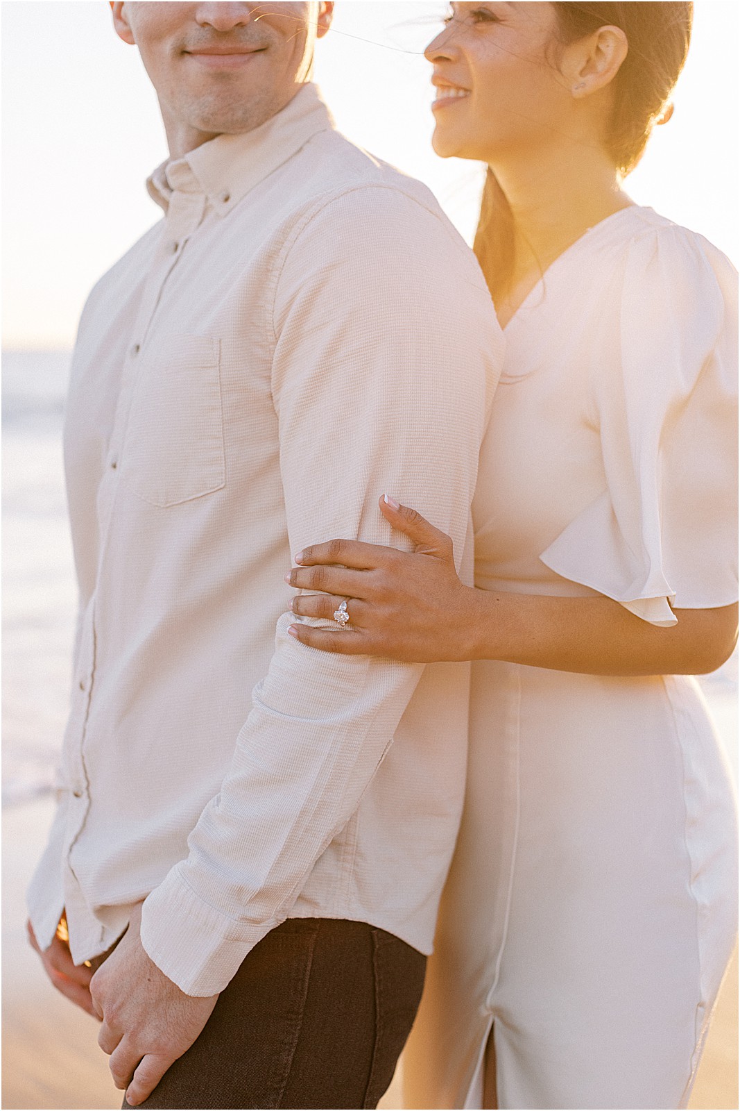 Close-up of couple showcasing engagement ring at Leo Carrillo Beach
