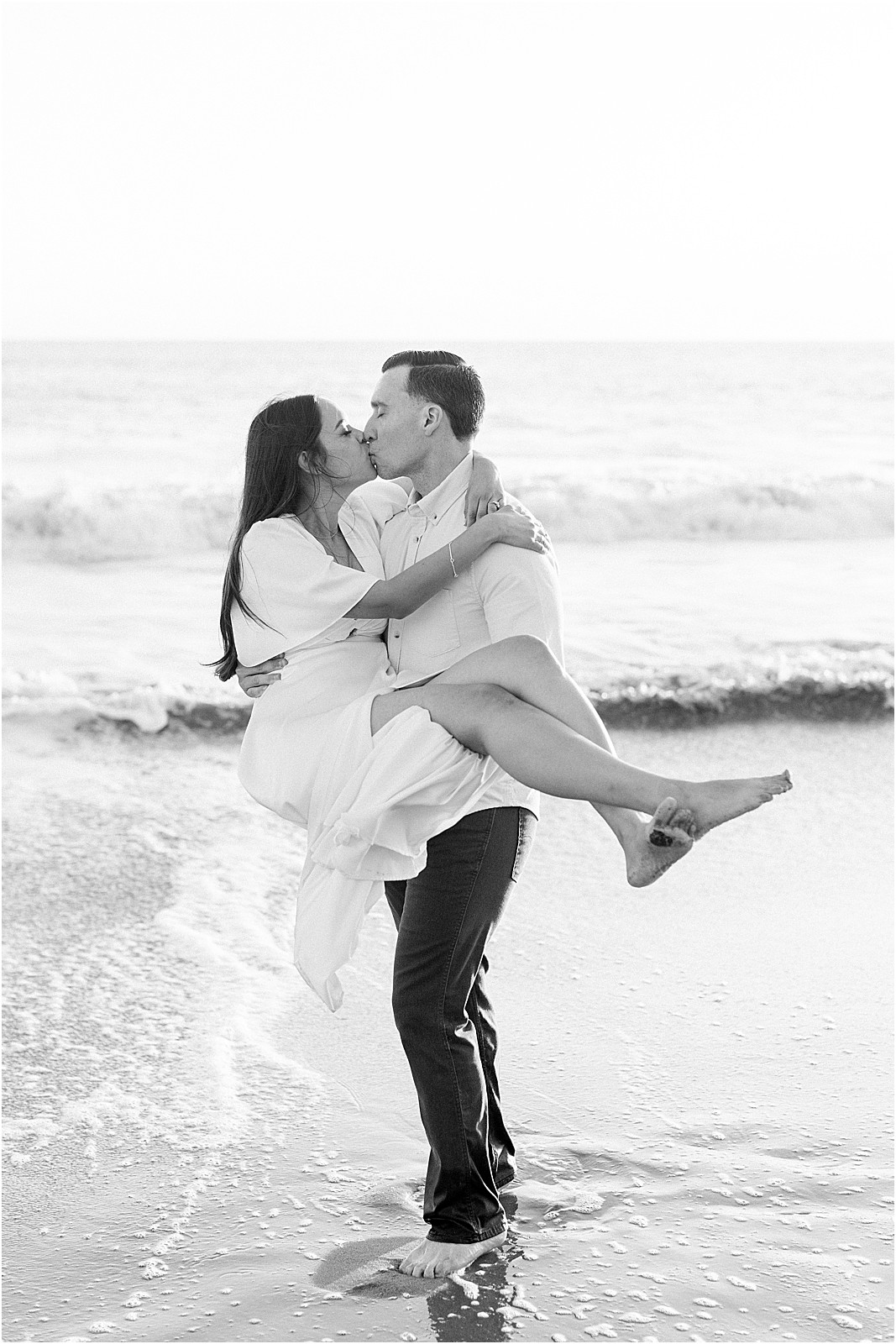 Black and white photo of couple embracing on the beach at Leo Carrillo, Malibu.