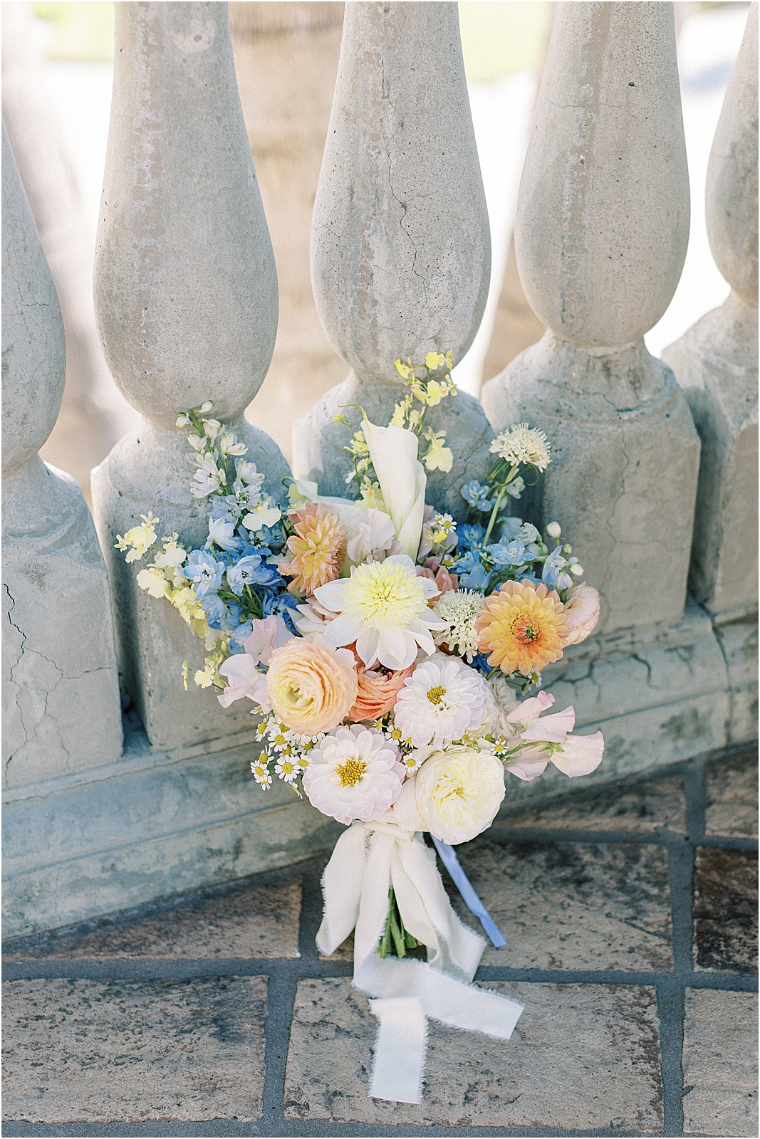 bridal bouquet with colorful florals leaning against bridal suite