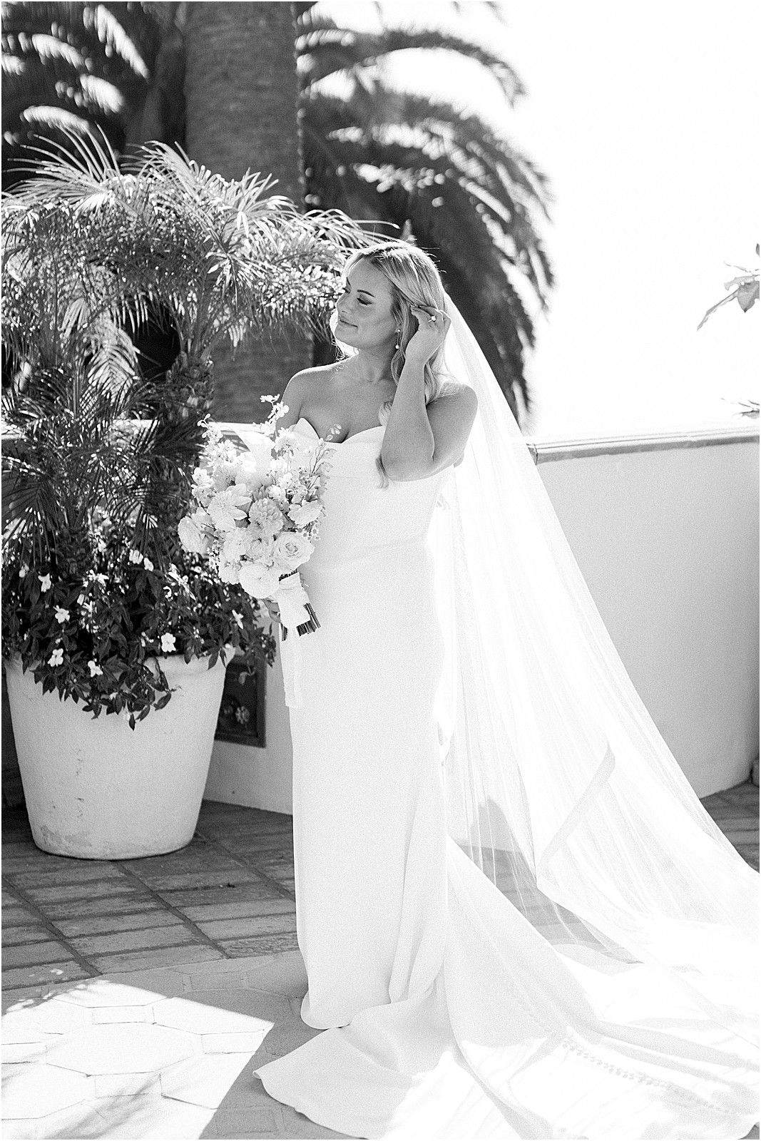 bride putting on earrings in soft natural light