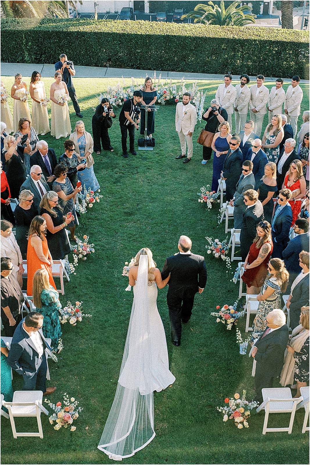 wide overhead photo of bride walking down the aisle with father