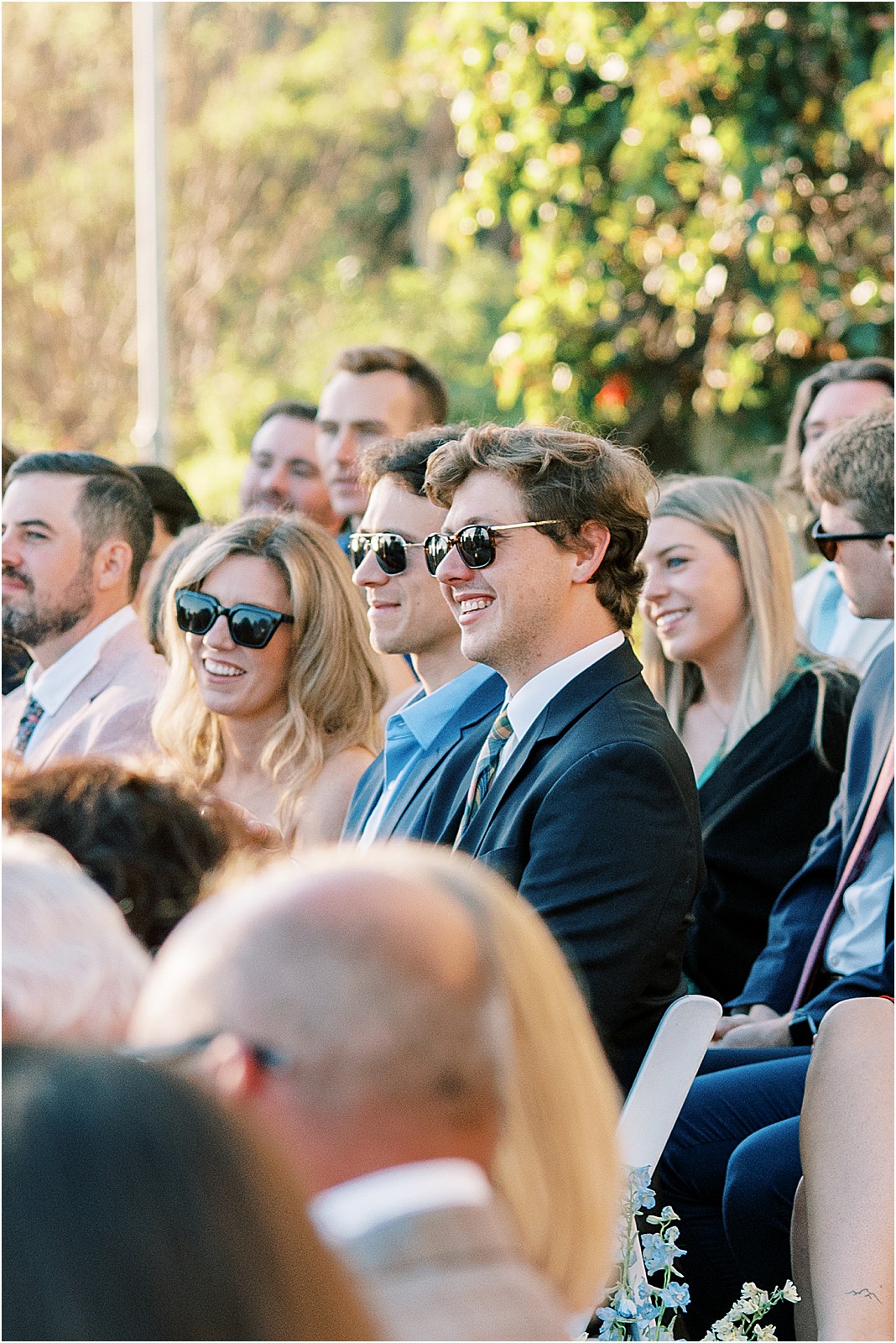 candid capture of guests laughing during ceremony