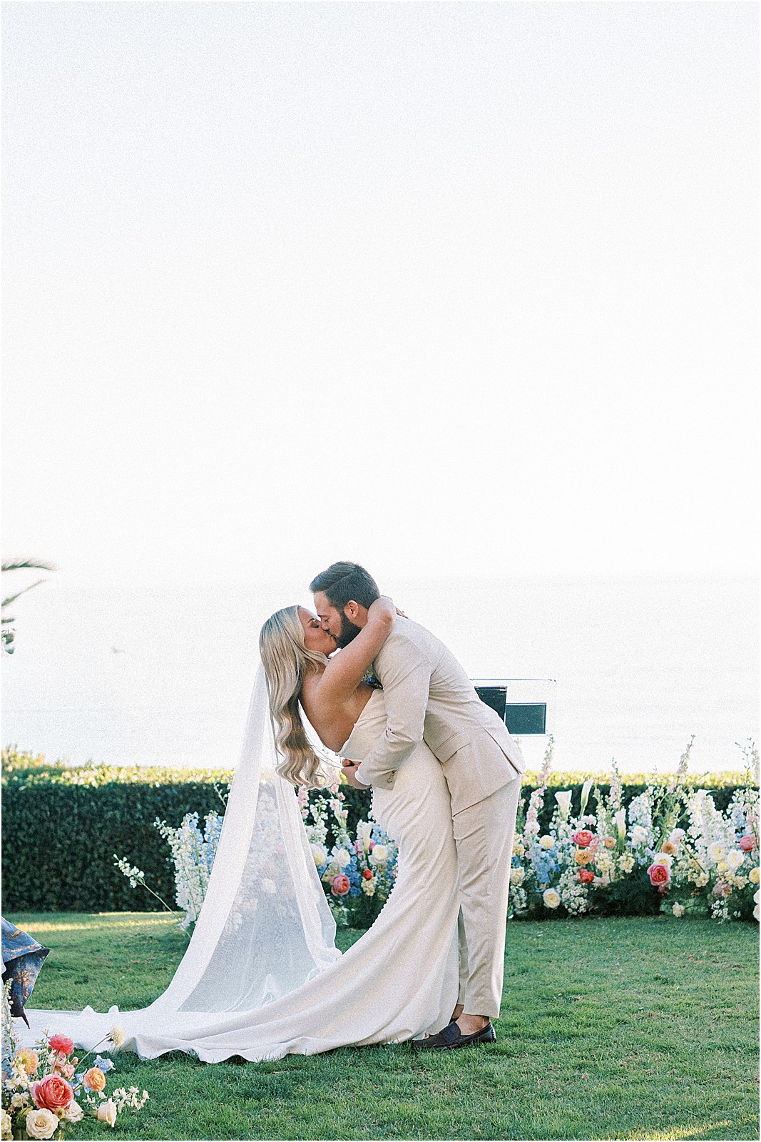 first kiss with ocean views behind the newlyweds