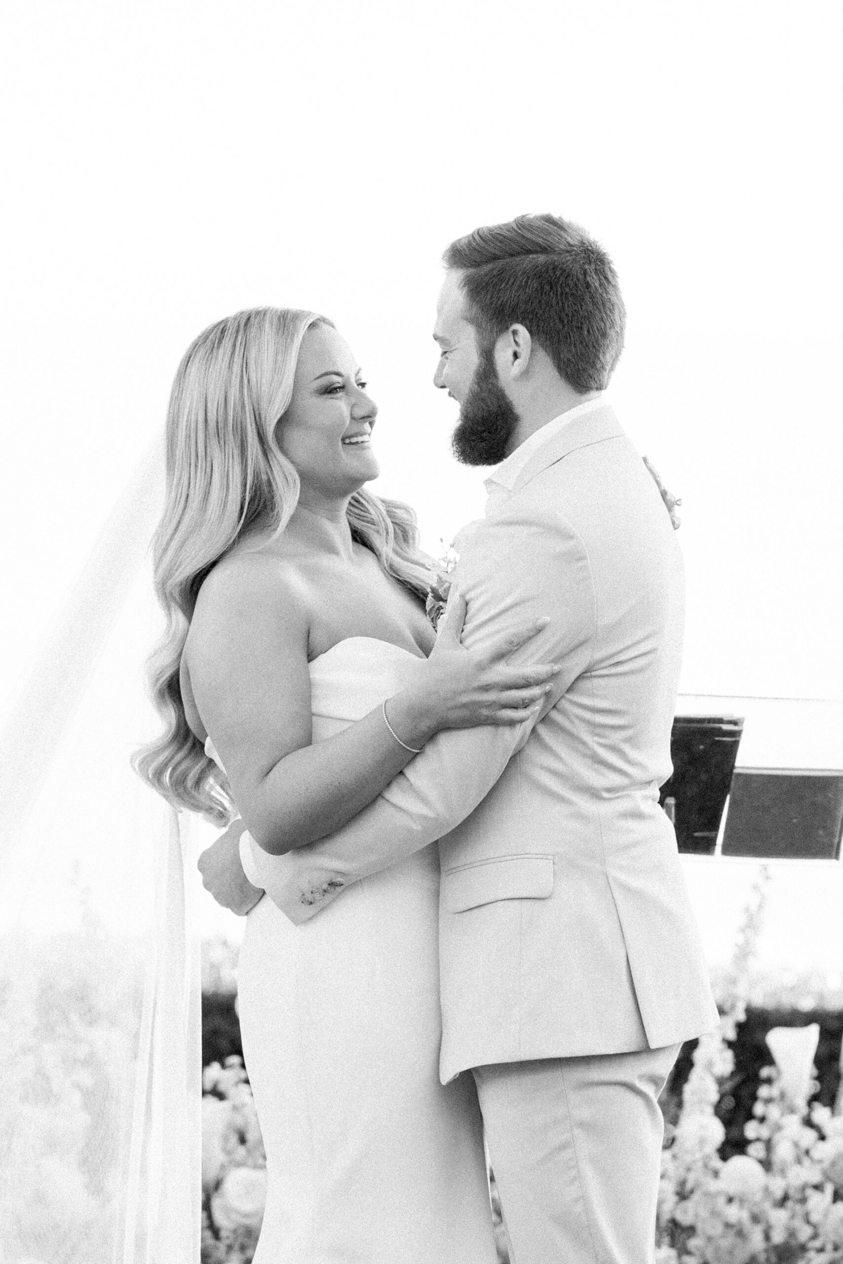 bride and groom smiling at each other and embracing during ceremony at bel air bay club