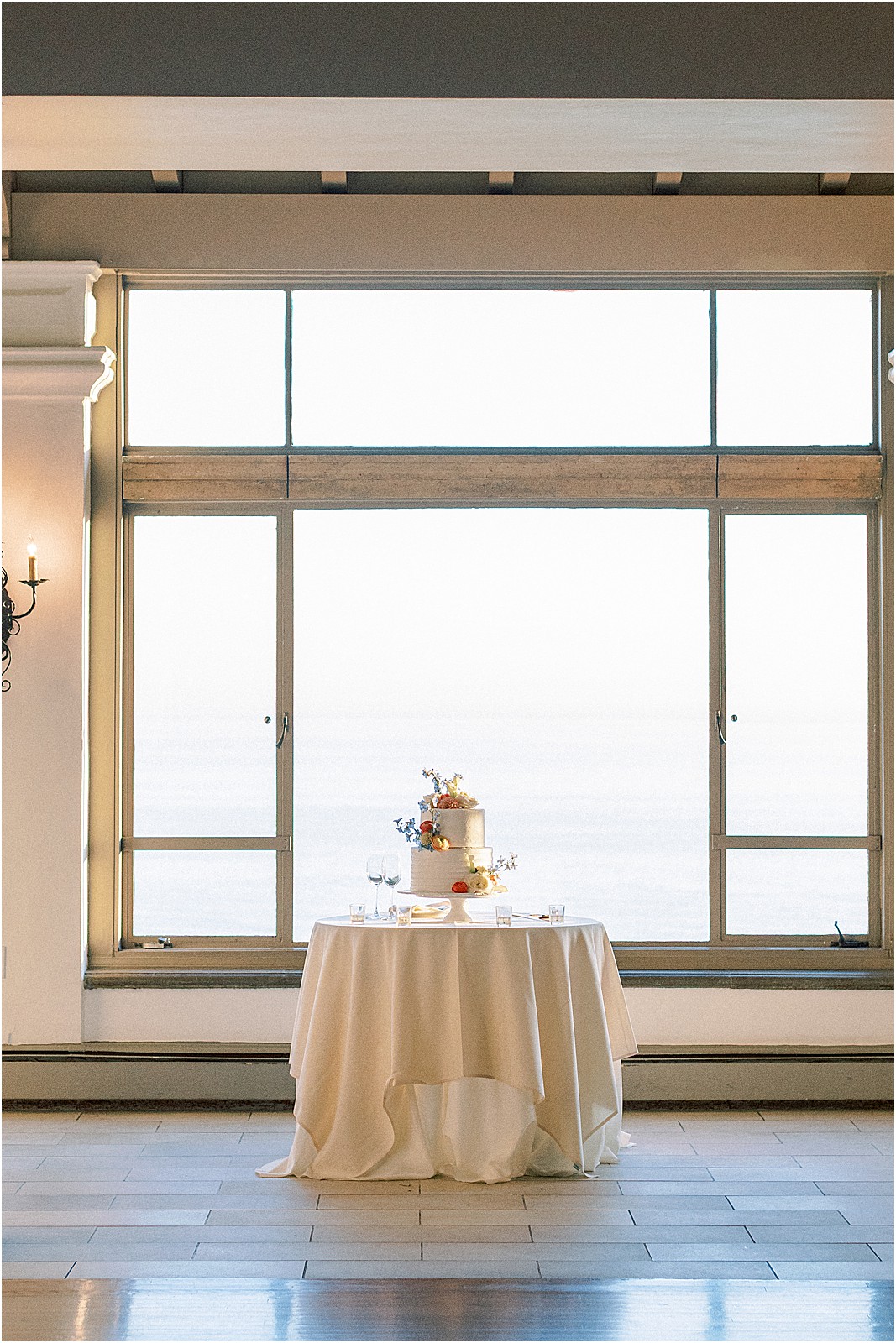 portrait of wedding cake with the pacific ocean behind