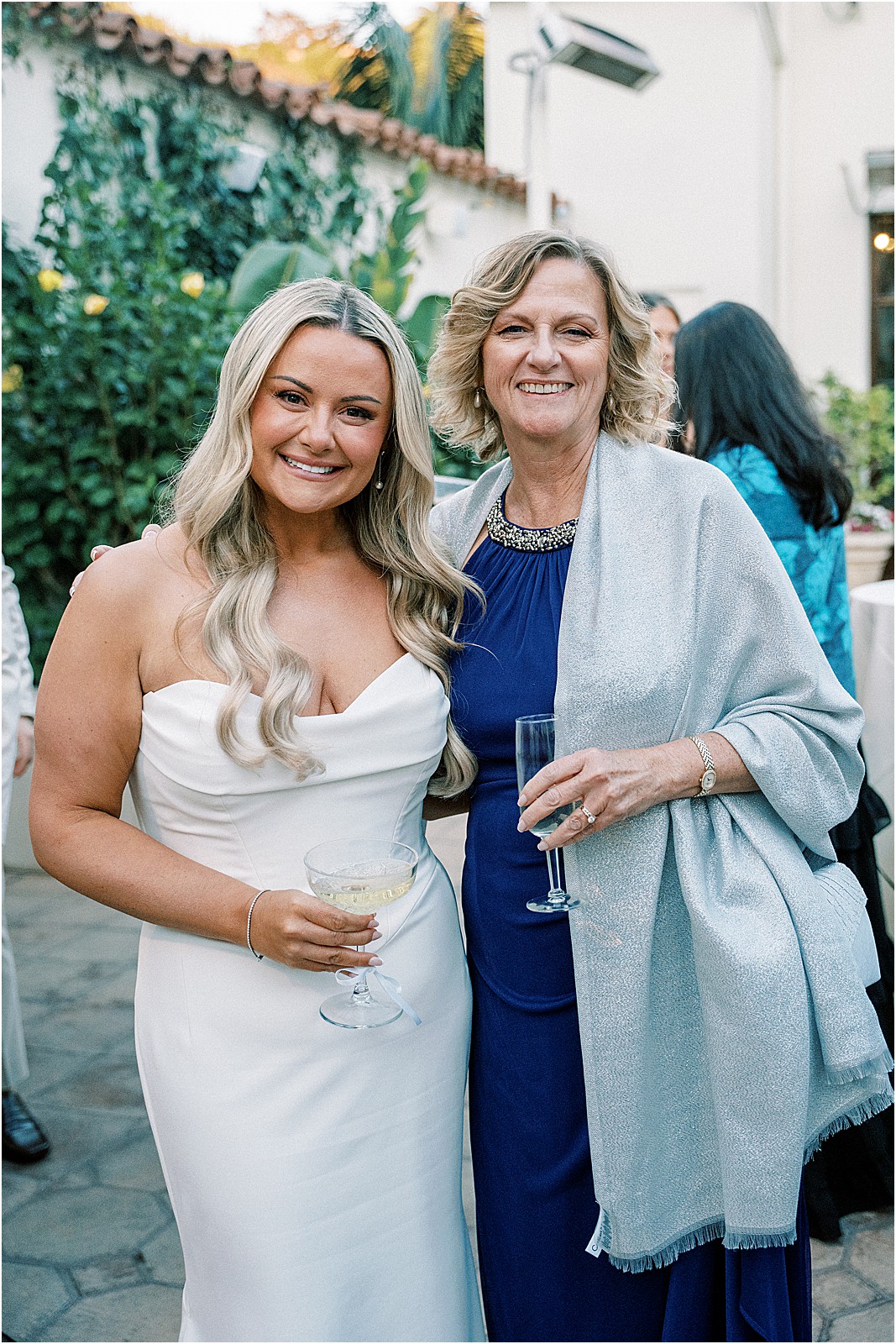 bride posing with her mother in law during cocktail hour