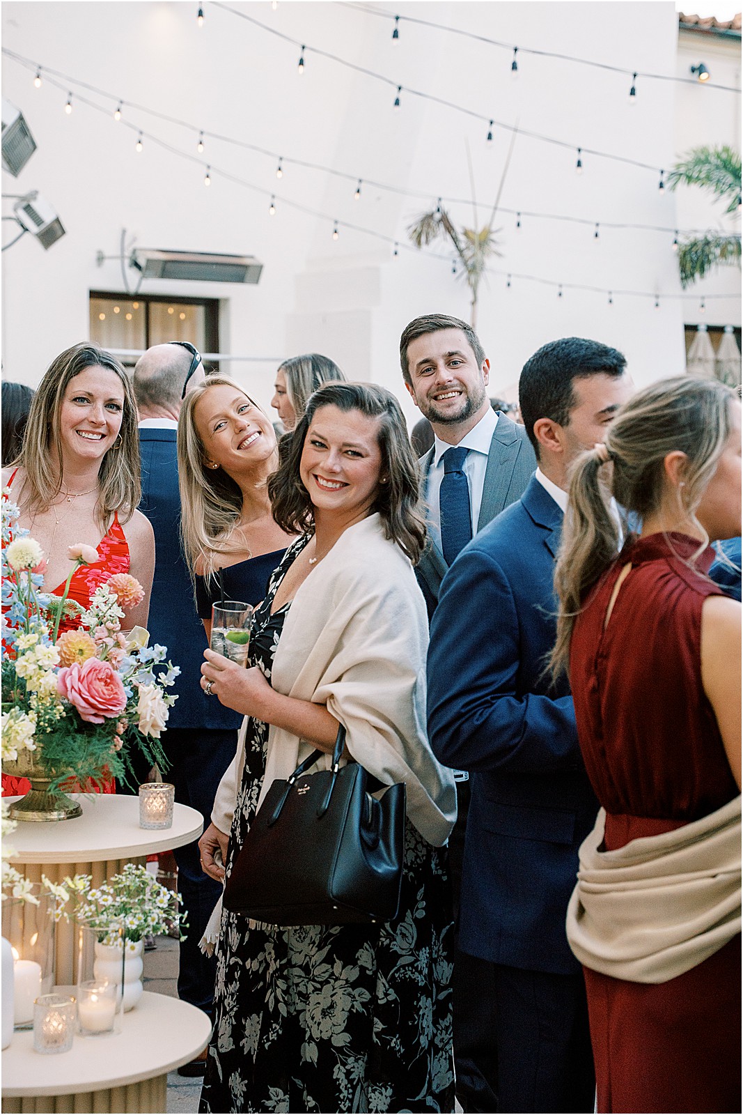 guests smiling at the camera during cocktail hour