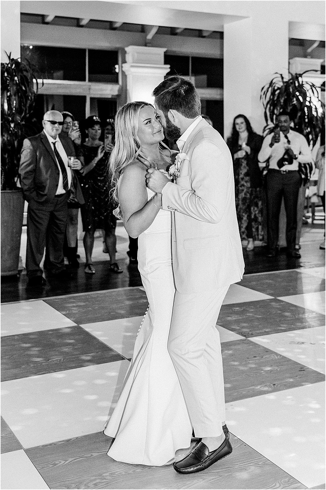 couple holding each other during their first dance at bel air bay club