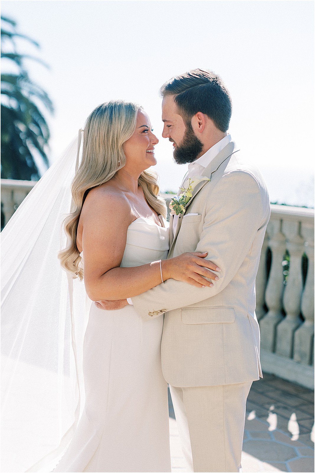 bride and groom smiling at each other under soft golden california light
