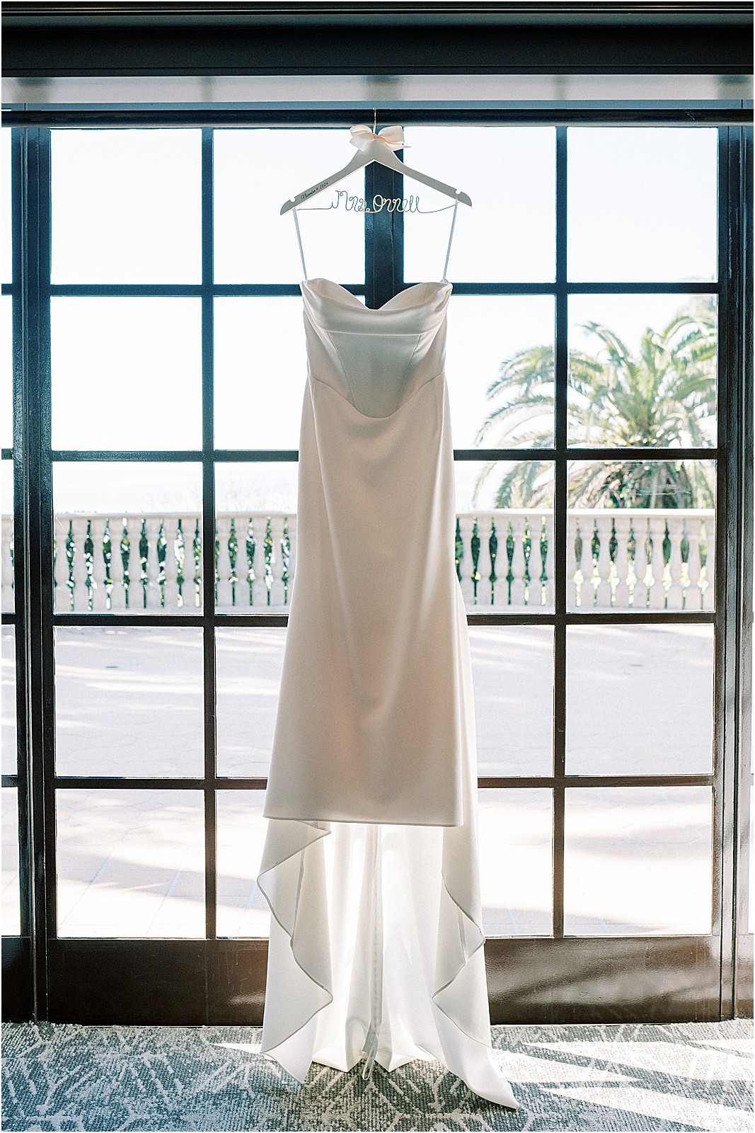 wedding dress hanging on door of bridal suite at bel air bay club in pacific palisades