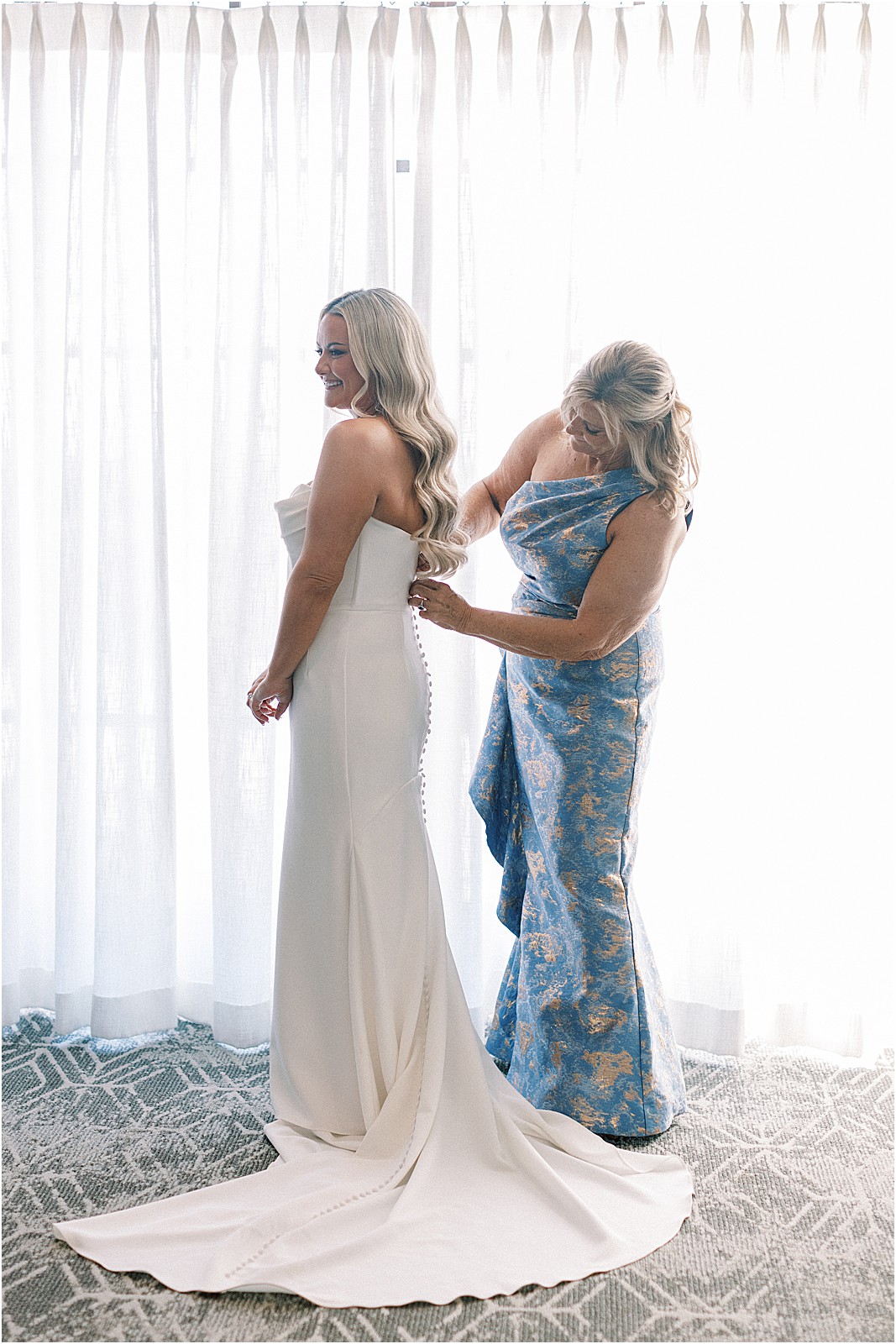 bride laughing with her mom during getting ready