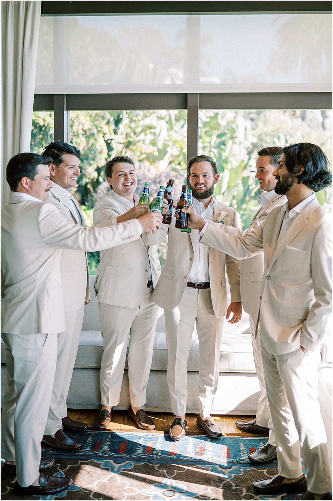 groomsmen sharing a toast in the getting ready room at bel air bay club