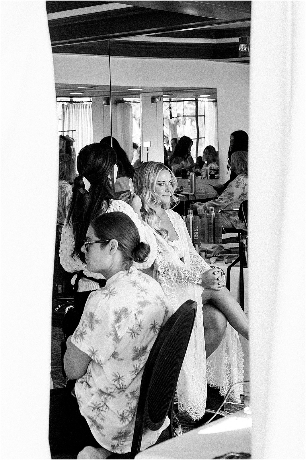 bride sitting in makeup chair for final touches at bel air bay club