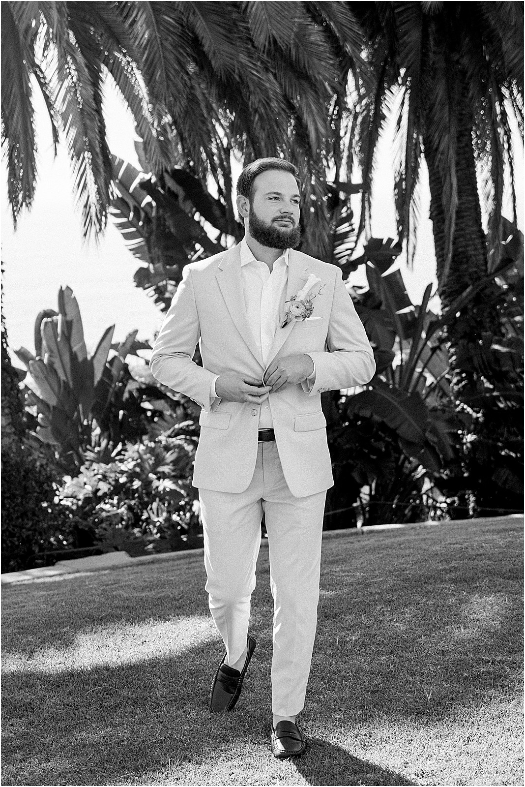 groom buttoning his jacket before first look at bel air bay club