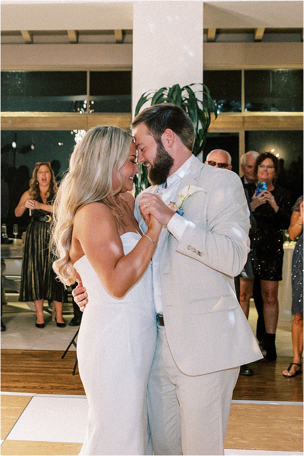 bride resting her head on the groom during their first dance