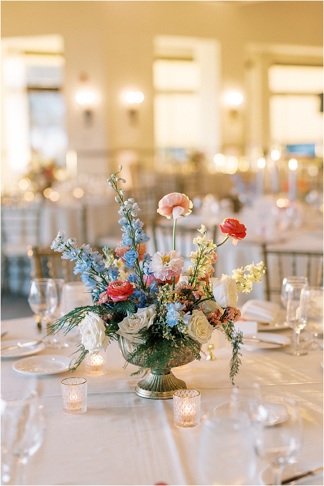 reception tablescape with candles and vibrant florals at bel air bay club wedding