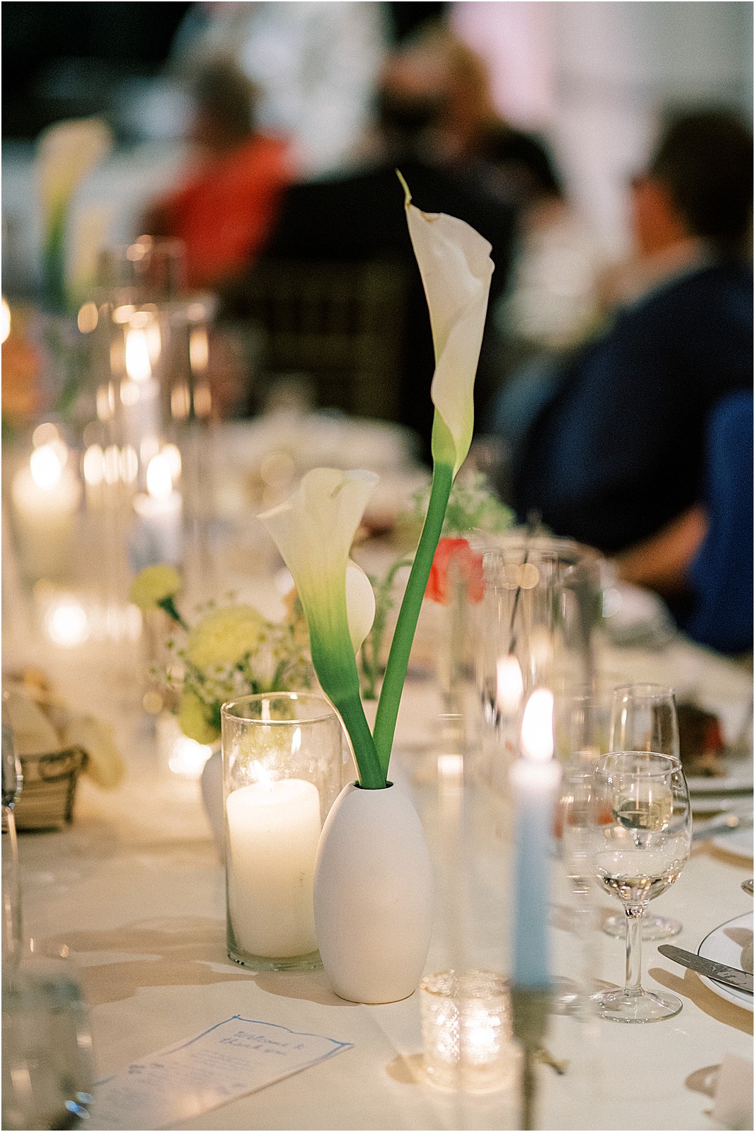 a candle filled table with florals during toasts