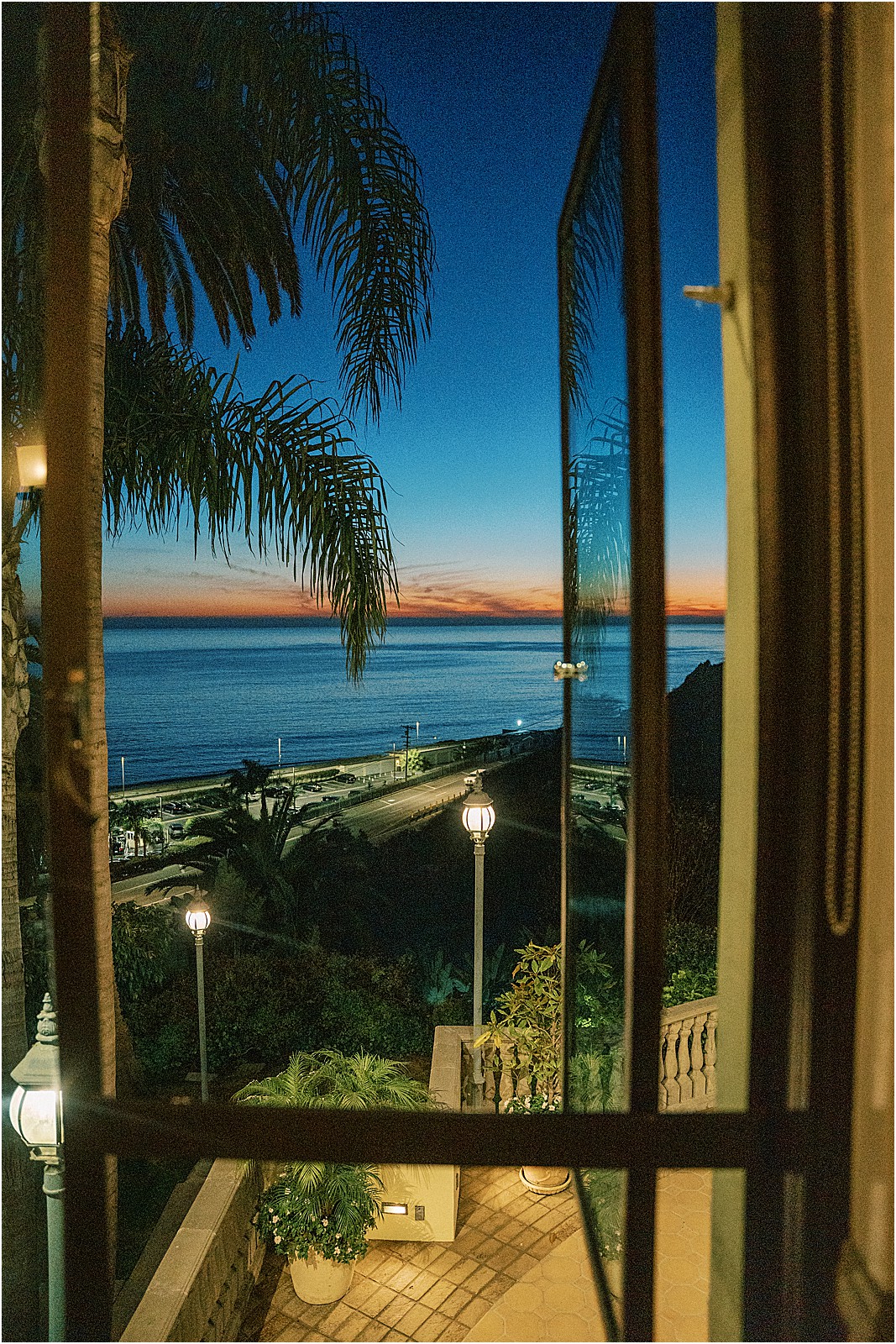 the pacific ocean from the reception as the sun just set in pacific palisades