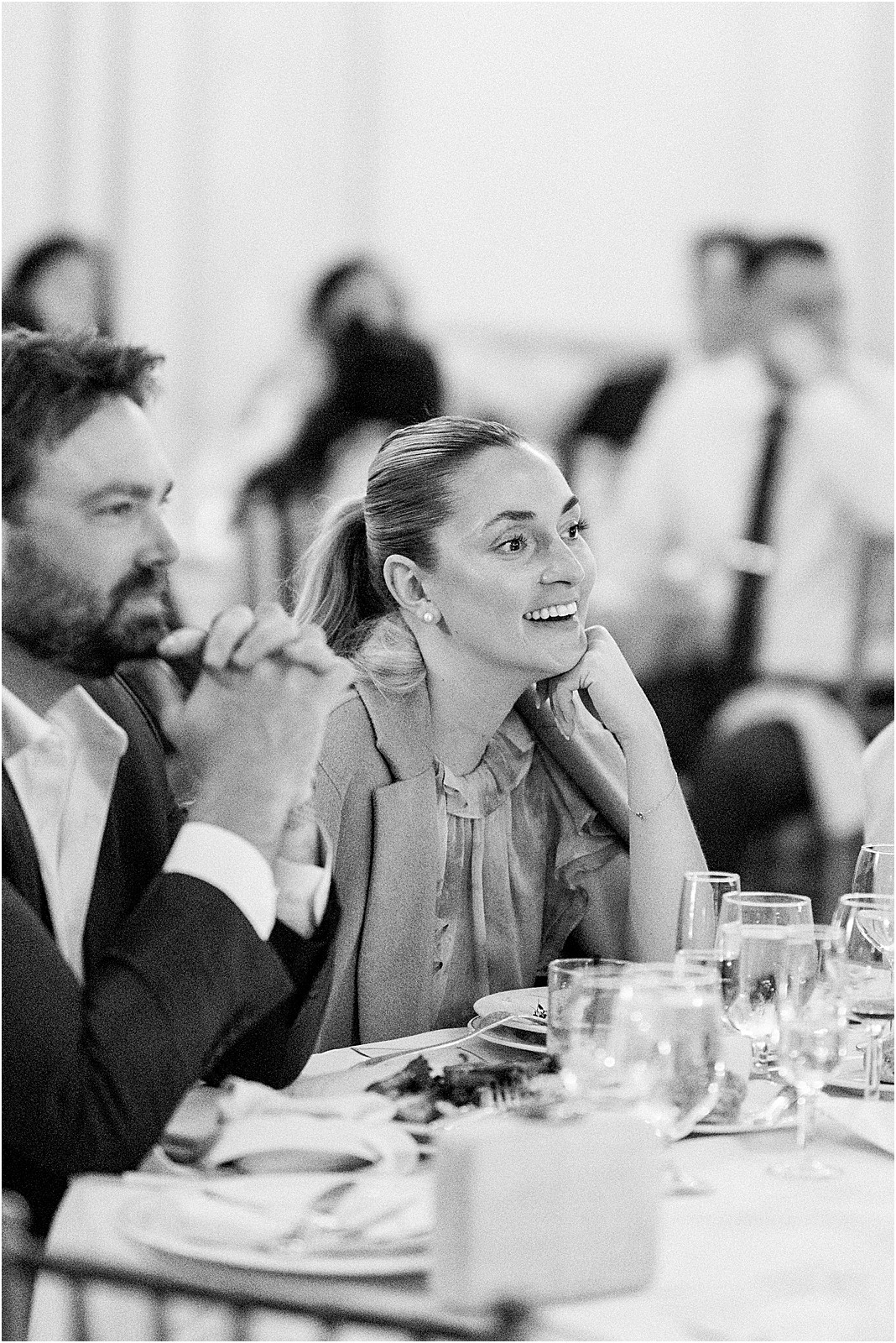 friends smiling during toasts at reception
