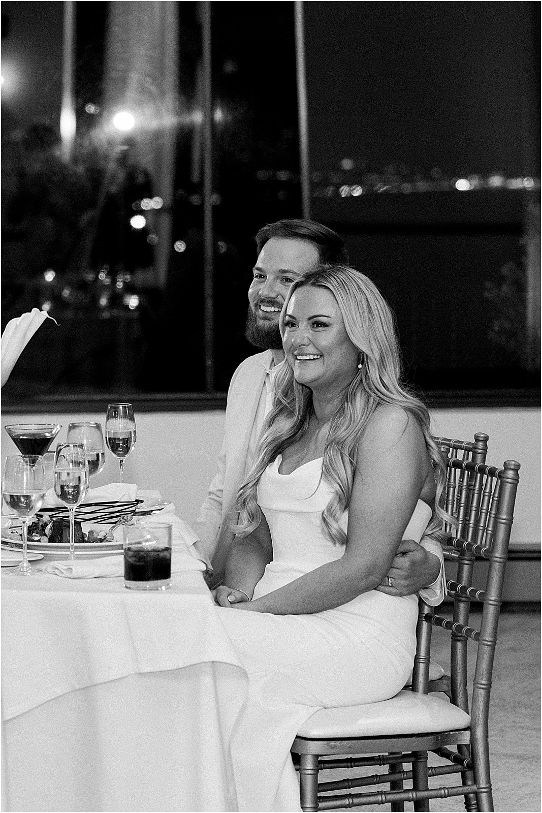 couple reacting with laughter during reception toasts