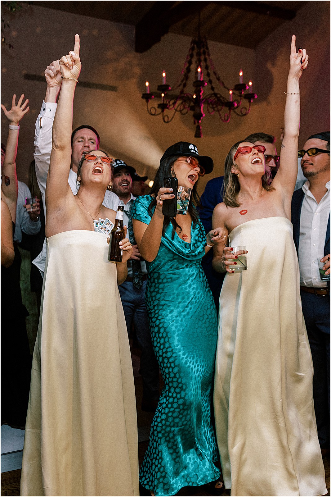 guests cheering the couple cutting their wedding cake