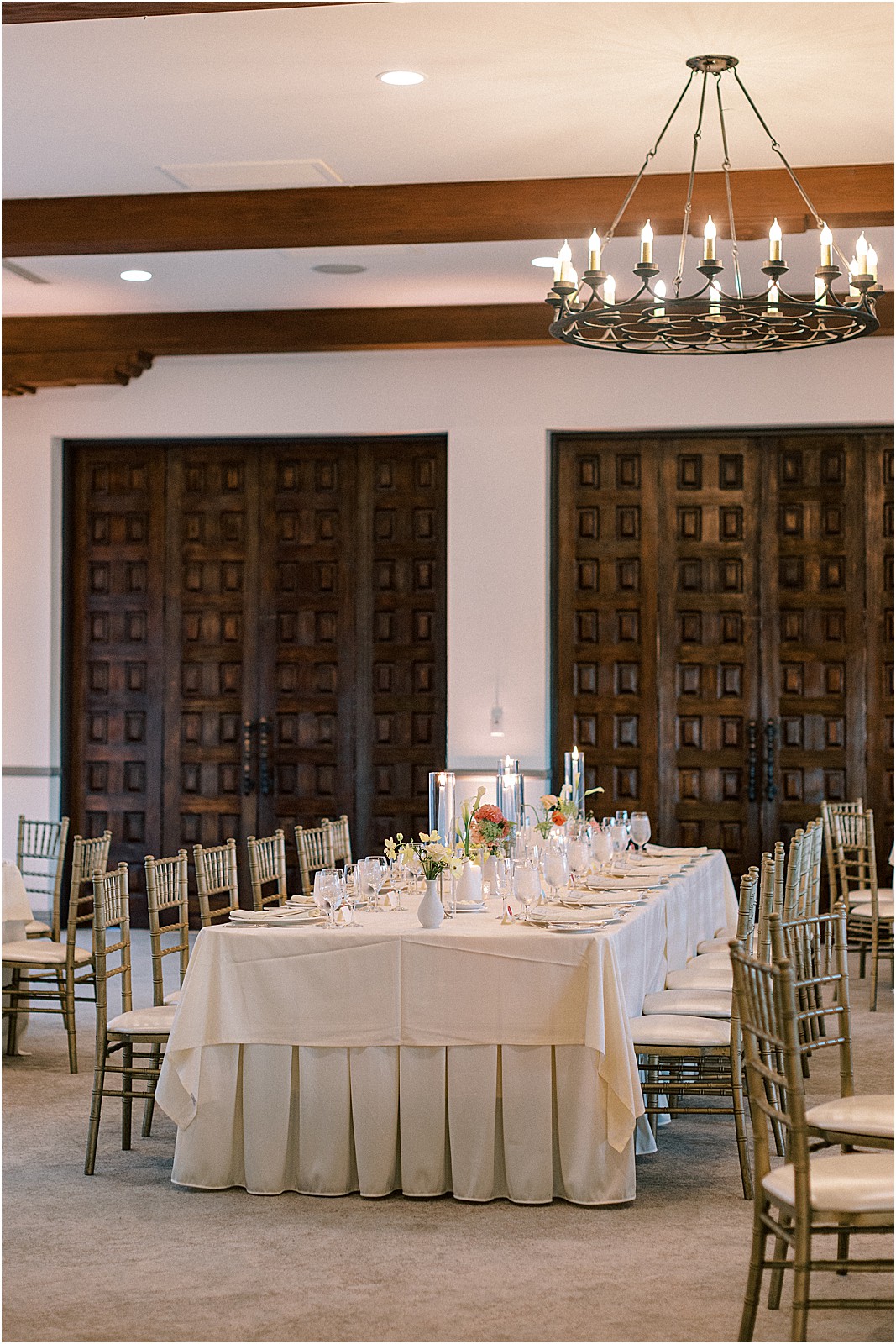 reception tablescape with candles and vibrant florals
