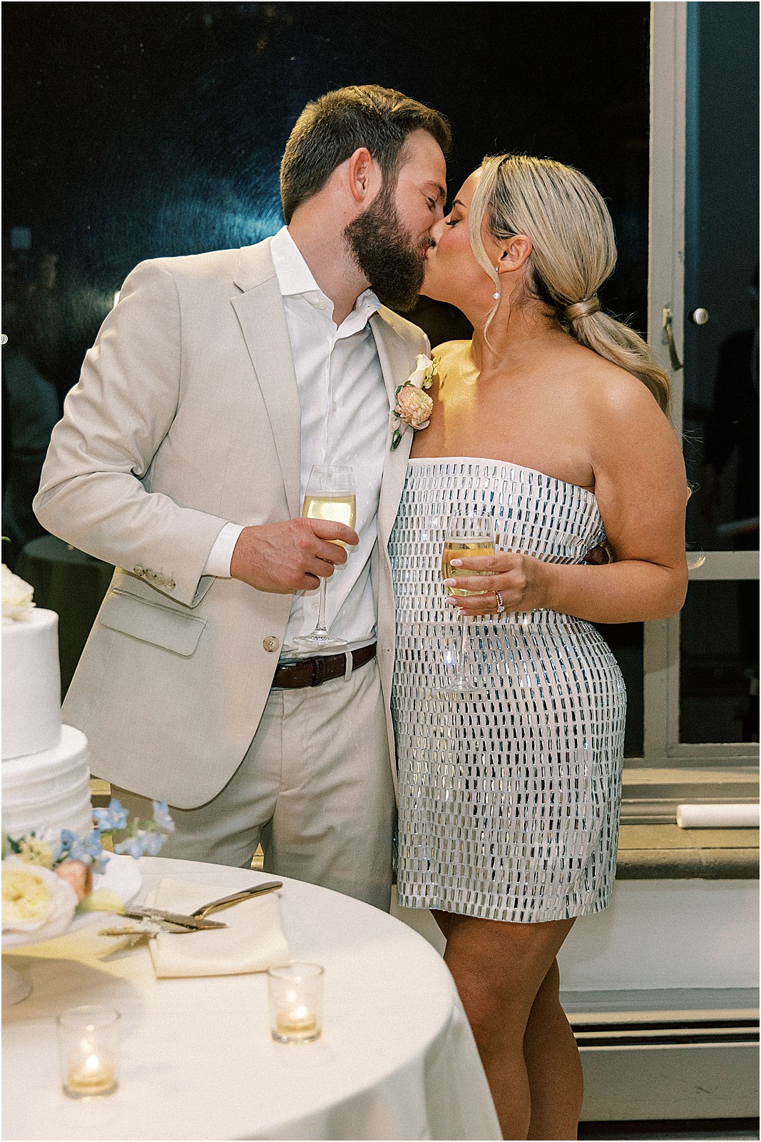 the couple kissing after cutting their wedding cake at bel air bay club