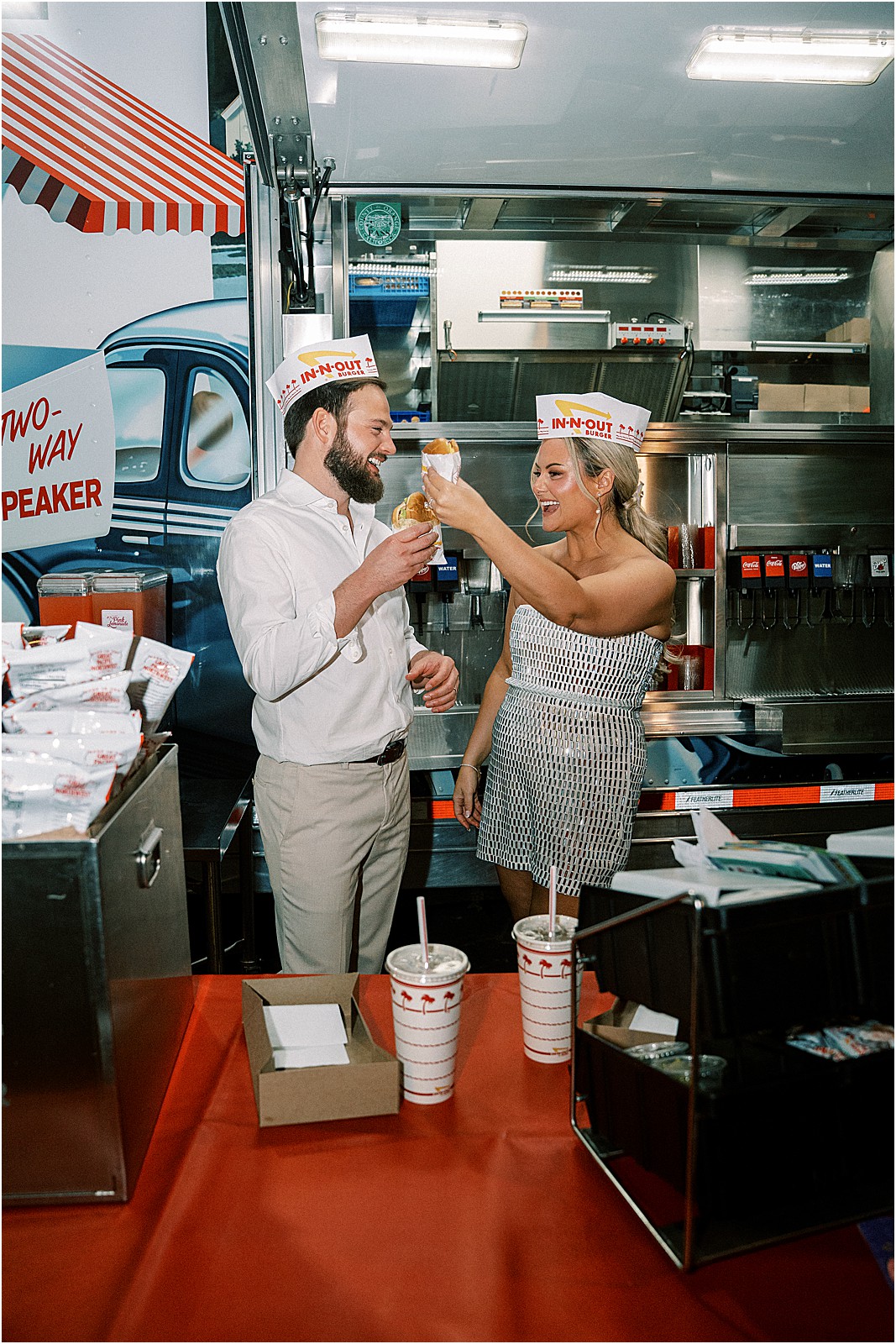 bride and groom cheers-ing with cheeseburgers from the in and out truck at bel air bay club