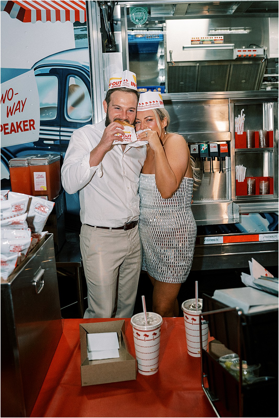 bride and groom eating cheeseburgers during late night photos at bel air bay club