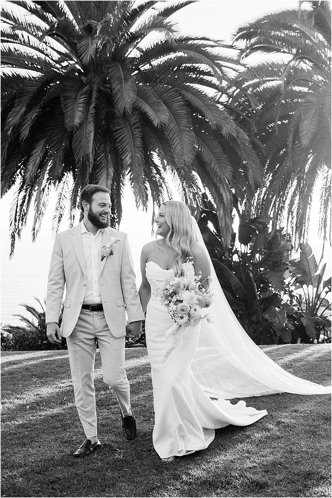 couple walking hand in hand on lawn at bel air bay club