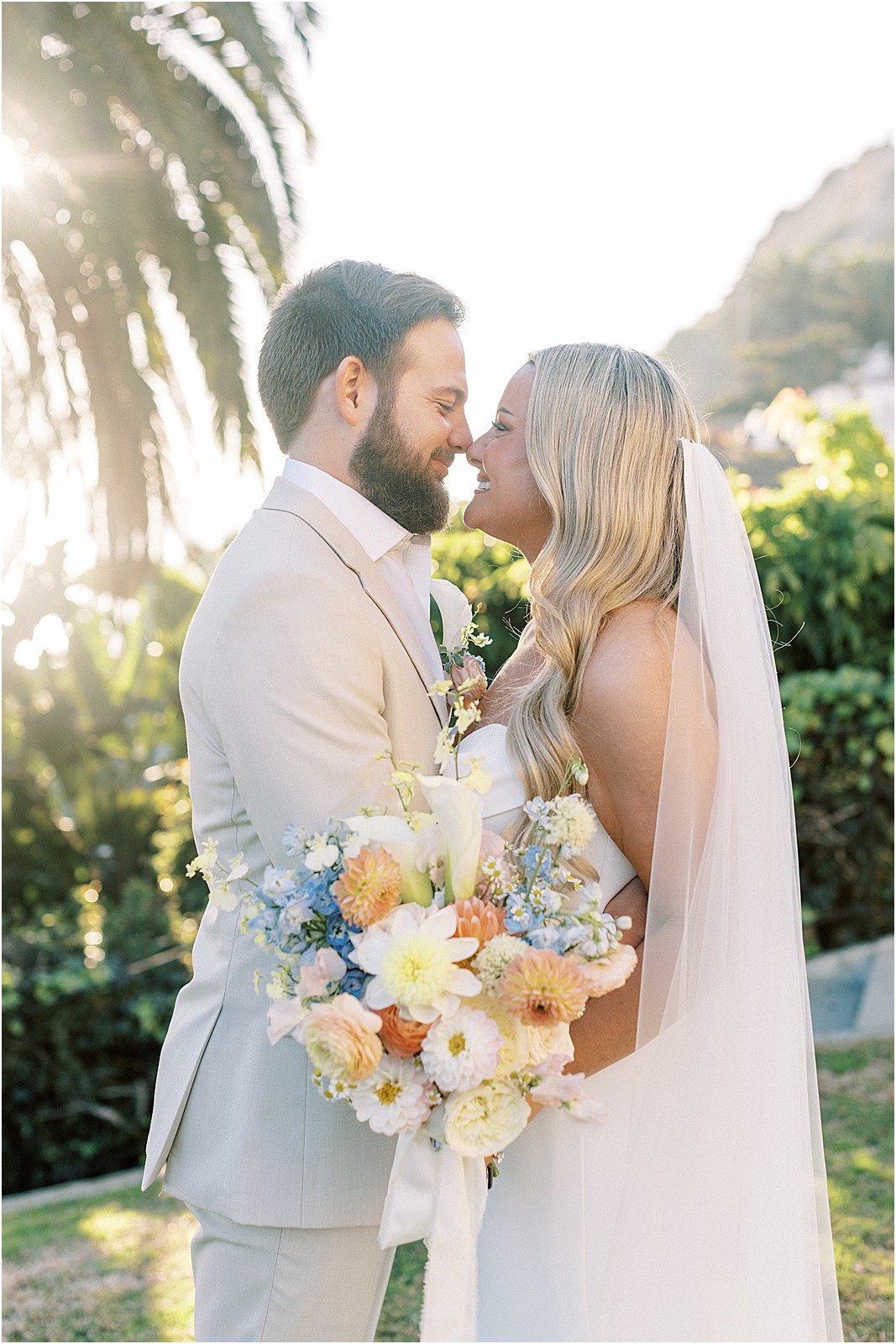 candid portrait of the couple laughing together at sunset