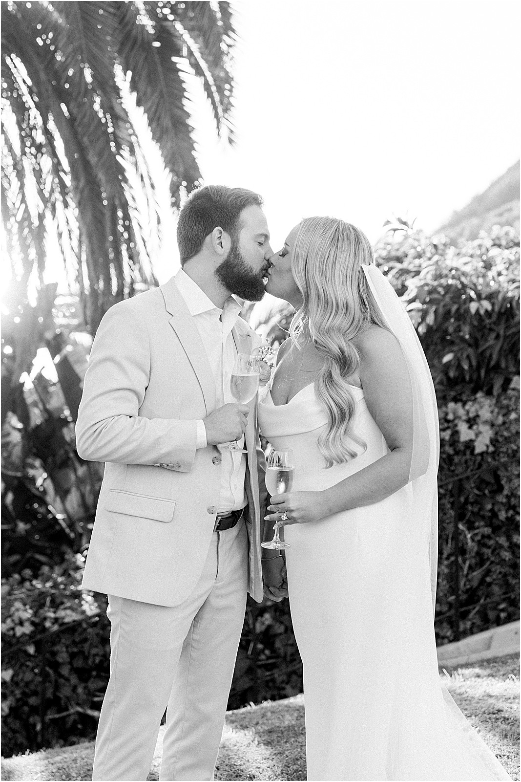 couple kissing while toasting with champagne