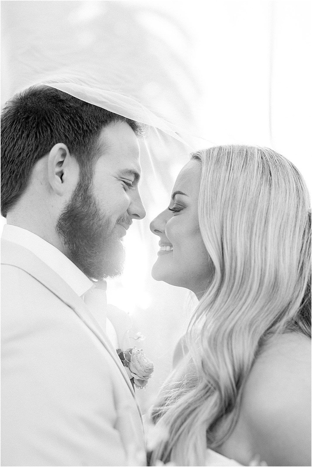 groom holding bride close during sunset photos