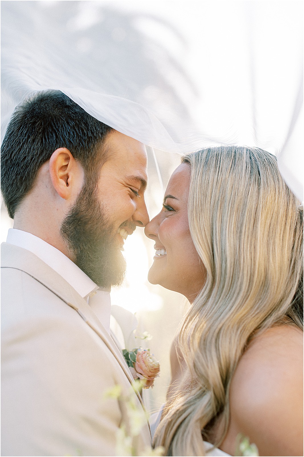 groom holding bride close during sunset photos at bel air bay club