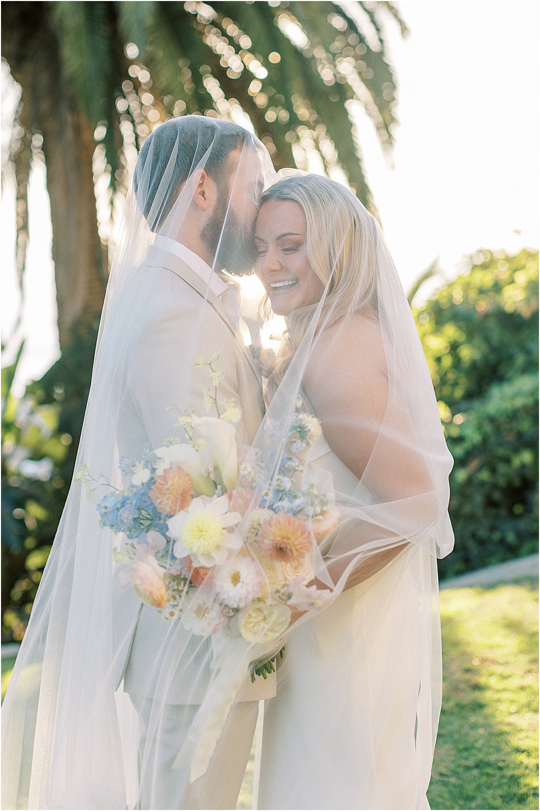 groom kissing bride on the temple at bel air bay club