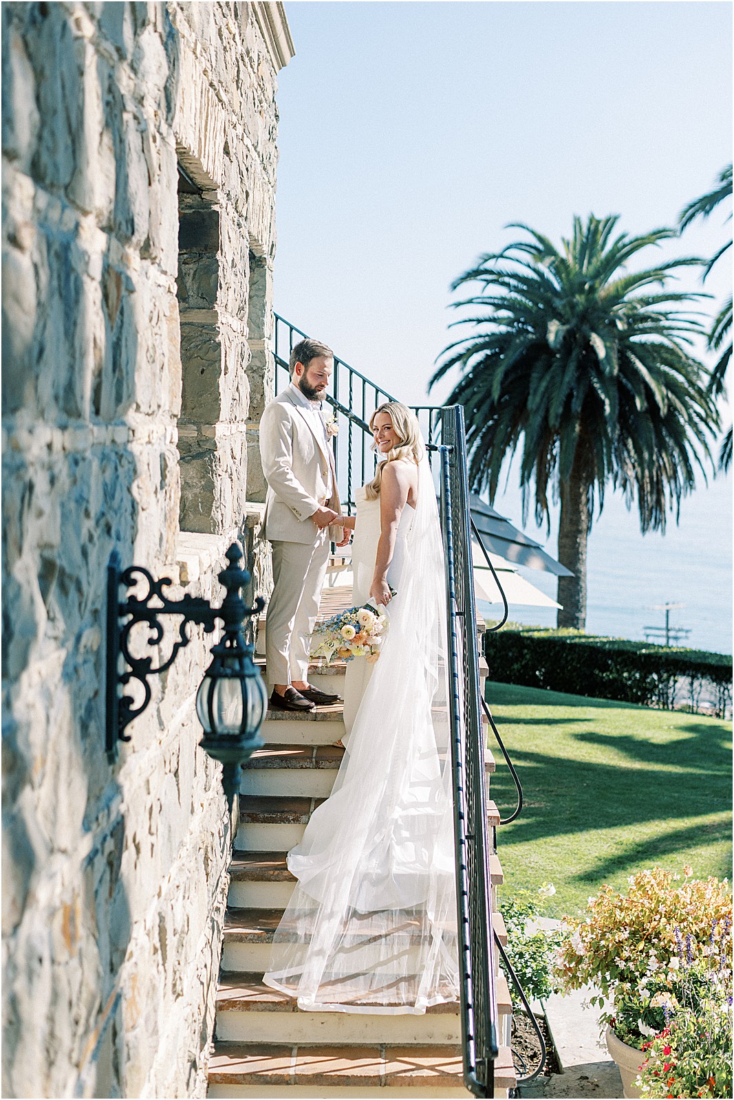 groom leading the bride up the stairs before their wedding at bel air bay club