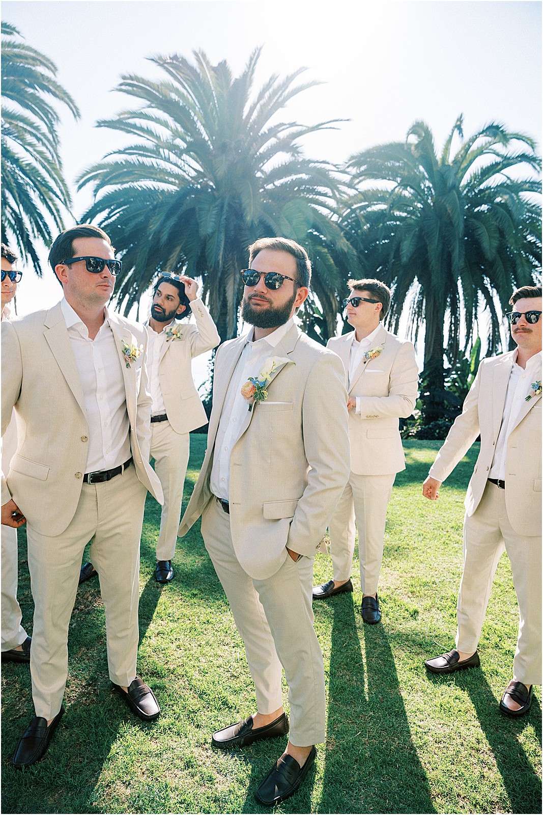groom with groomsmen hanging out around him